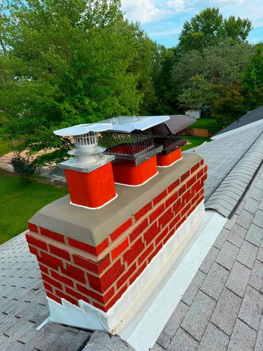 Rebuilt brick chimney with a new crown, flue liners and chimney caps